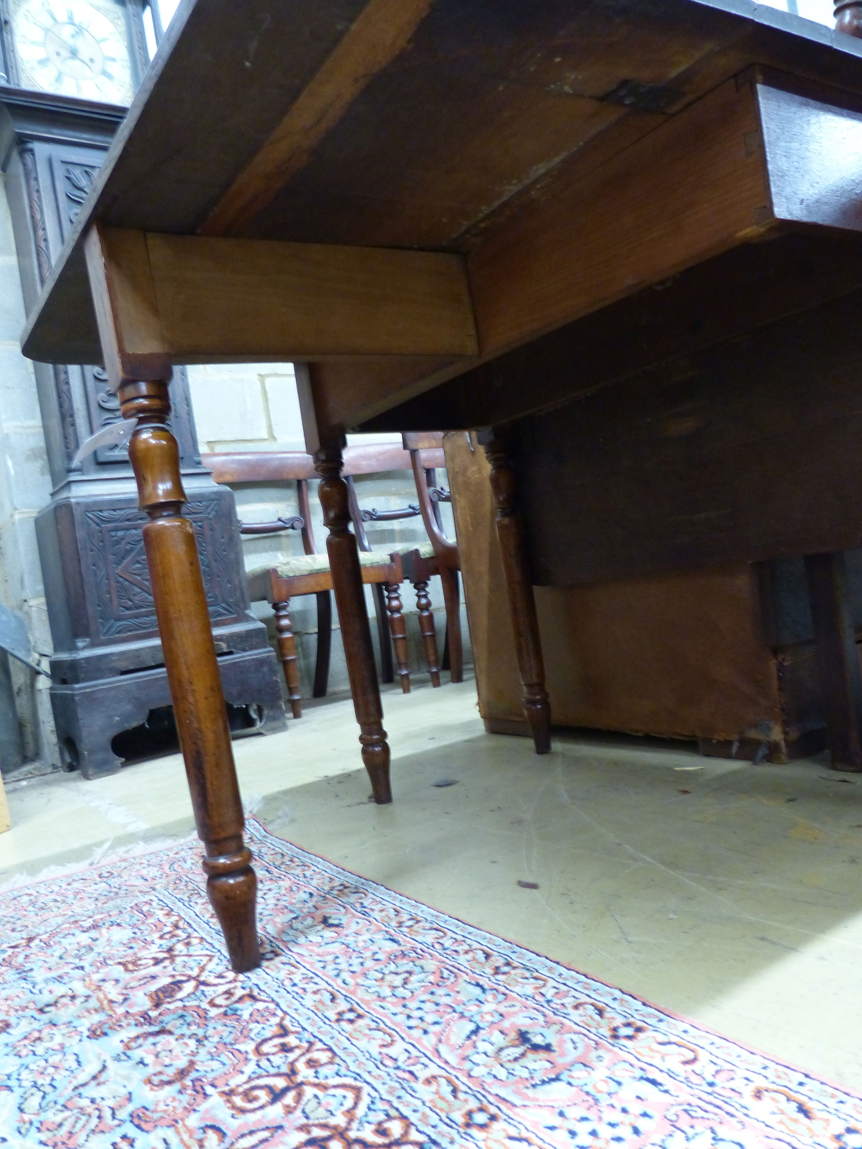 An early Victorian oak drop leaf dining table, length 90cm